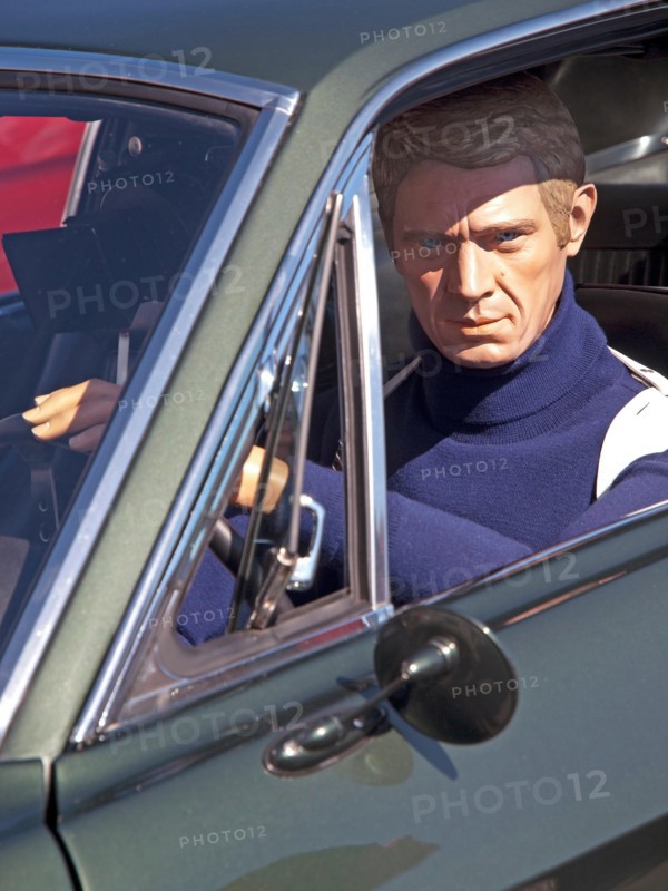At a classic car rally in Brighton sits a model of the actor Steve McQueen as seen in the film Bullitt