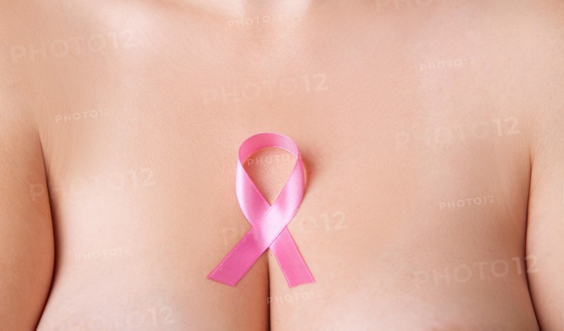 Nude woman breast with pink ribbon. Breast cancer symbol