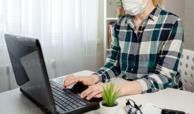Woman in medical mask working office work remotely from home