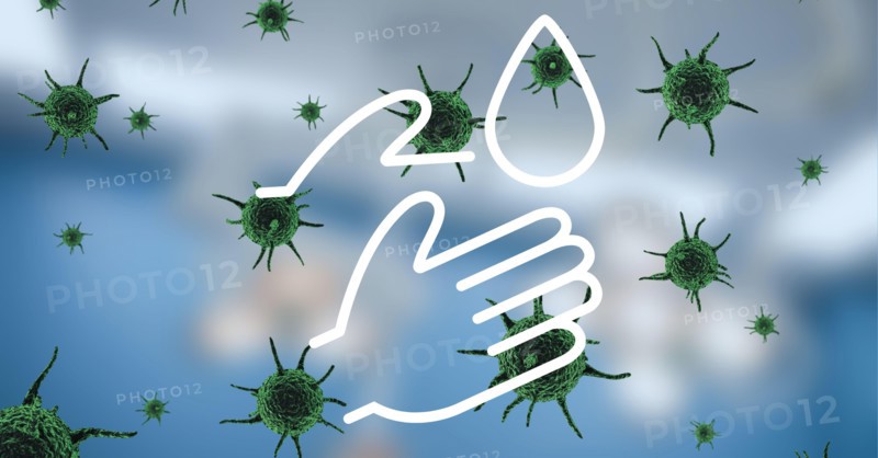 Digital illustration of a washing hands sign over Coronavirus Covid=19 cells spreading