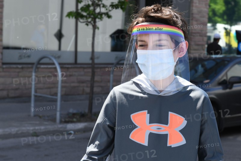Boy wearing protective face masks and face shields during Covid-19 Pandemic in Montreal Canada (Model released)