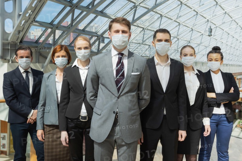 Business people wearing surgical protective masks and standing together, healthcare and covid-19 prevention concept