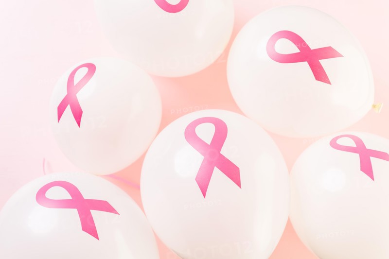 White latex balloos with pink reibbons.