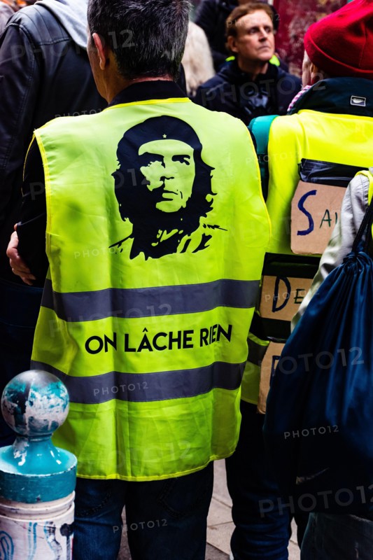 Marseille, France - January 25, 2020: A protester wearing a yellow vest during a 'marche de la colère' ('the march of anger') concerning housing issue