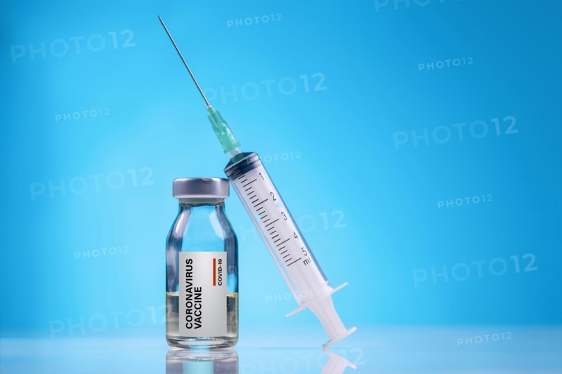 Coronavirus Vaccine / Corona virus Vaccine concept with Vial and Syringe on blue background