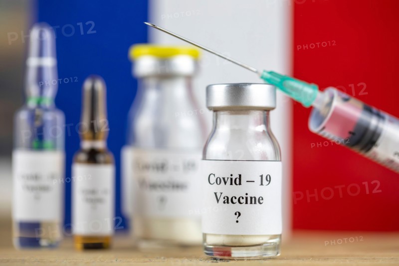 France Flag and bottle with vaccine and syringe, Coronavirus, Covid-19, Medicine, science and healthcare concept