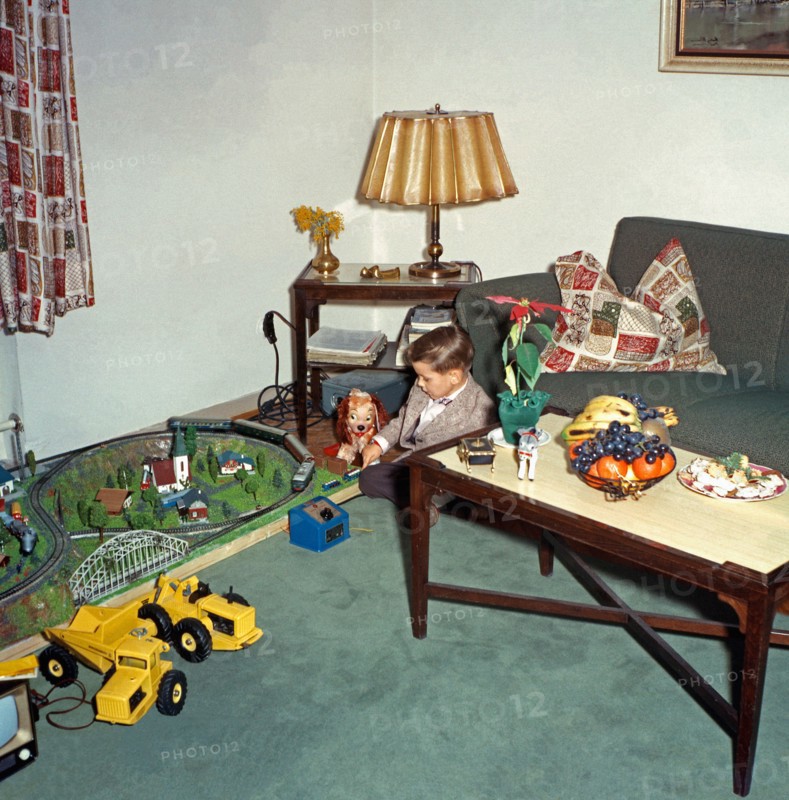 Boy playing with his new train set at Christmas, c. 1960