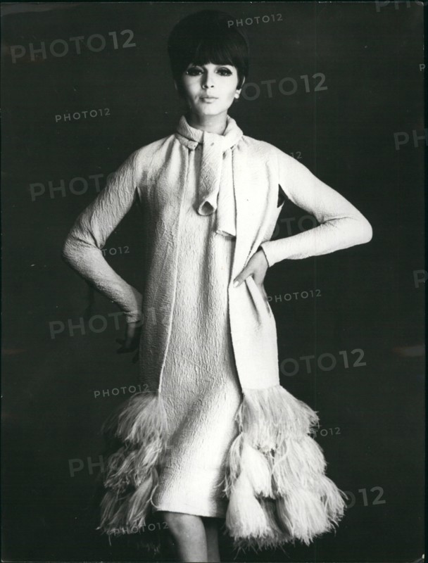Mar. 03, 1965 - Paris dressmakers show Spring and Summer collections. Photo shows Silk evening dress and coat trimmed with ostrich feathers at the bottom. Designed by Pierre Cardin.
