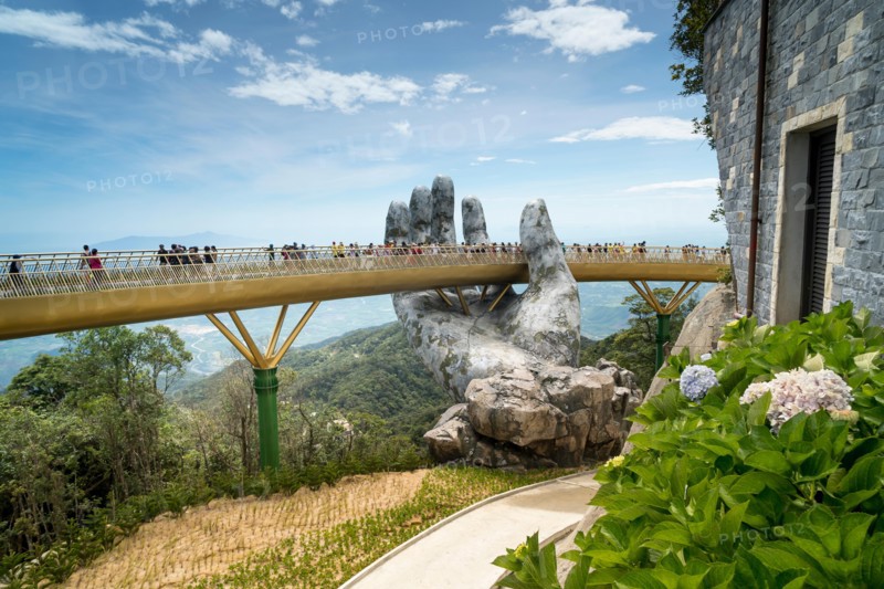 The panoramic view of Golden Bridge is lifted by two giant hands in the tourist resort on Ba Na Hill in Danang, Vietnam.