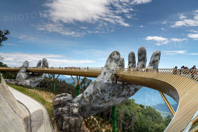 The Golden Bridge is lifted by two giant hands in the tourist resort on Ba Na Hill in Danang, Vietnam