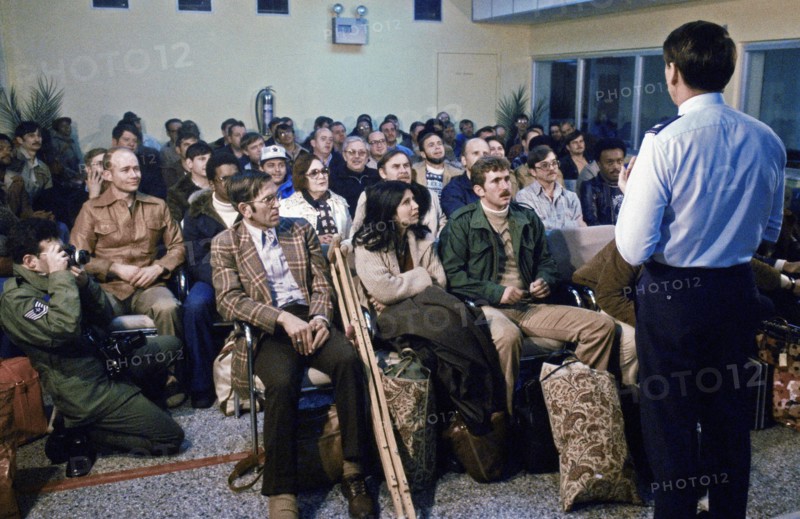 February 1979 - Evacuees from the US Embassy in Tehran, Iran, are briefed upon their arrival at the air base terminal.