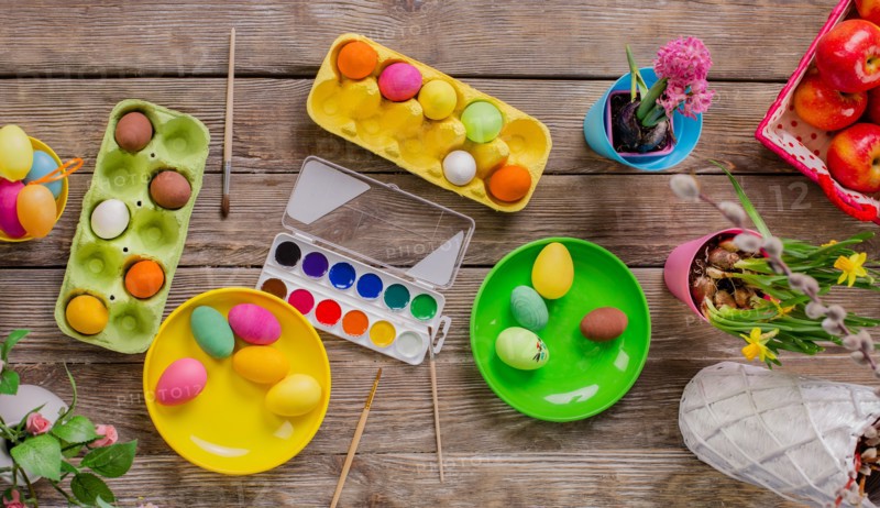 Easter. A happy family will paint eggs and get ready for Easter. Top view of the table with paints and eggs.