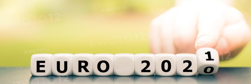 Hand turns dice and changes the expression "Euro 2020" to "Euro 2021".