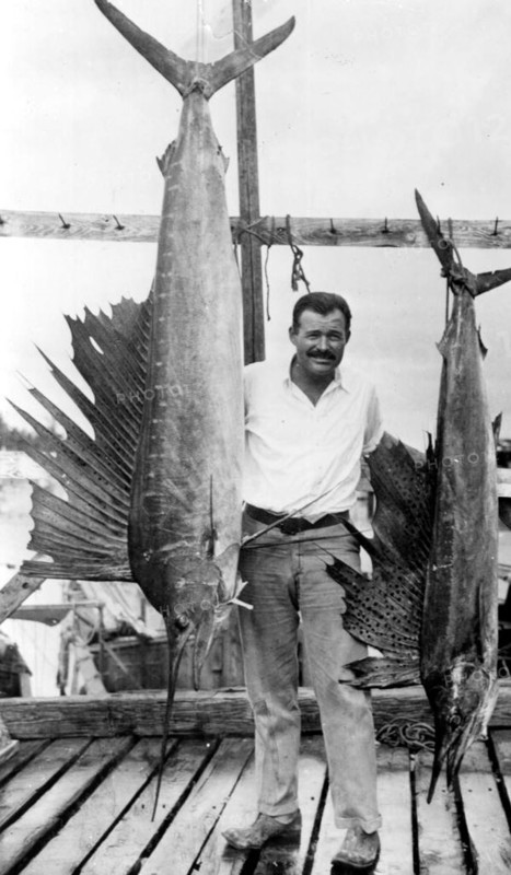 Portrait of author Ernest Hemingway posing with sailfish: Key West, Florida
