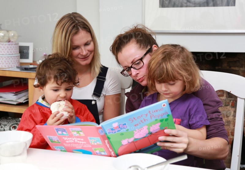 2 women reading to their kids