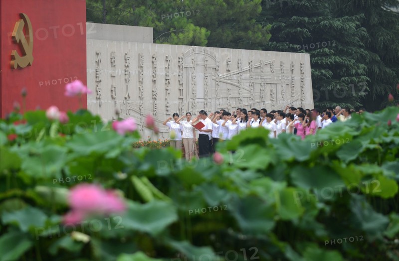 Chinese communists party members take an oath in front of the party flag sign at a Party Memory Mesume as part of celebrations for the July 1 Chinese Communist Party's 94th anniversary in JiaXing, Zhejiang province, East China on 29th June 2015.