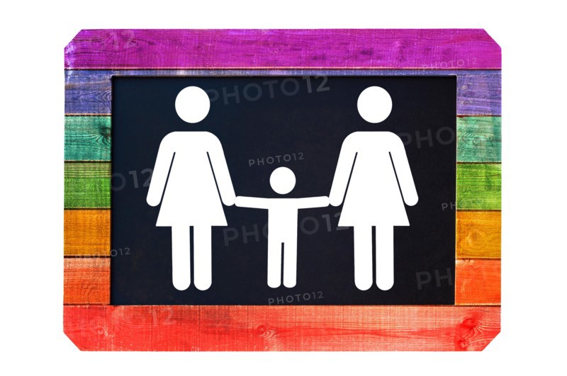 Lesbian family with child white sign on a blackboard, rainbow gay flag colors