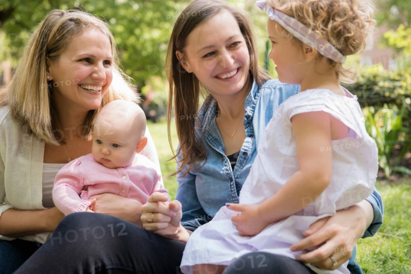 Caucasian mothers and daughters smiling in park