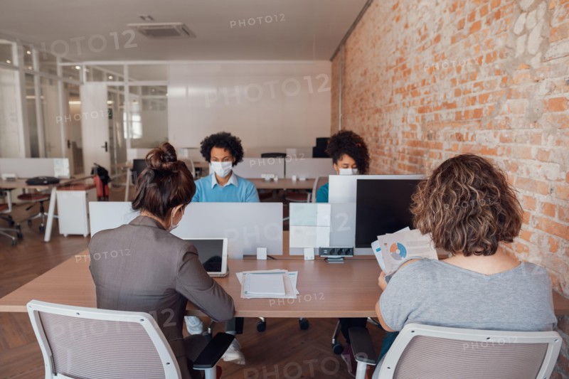 business colleagues working and typing on laptop and tablet in office workspace