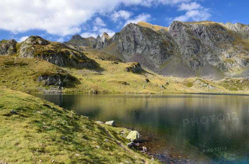 Alpine mountain lake Gentau under the peak Larry