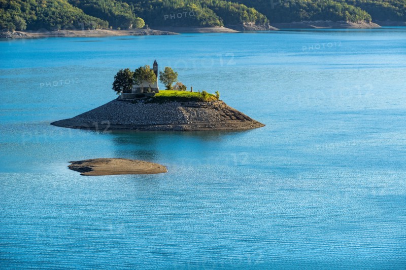 Saint-Michel Chapel and Serre-Poncon Lake in summer. Saint-Michel Bay, Hautes-Alpes, PACA Region, Southern French Alps, France