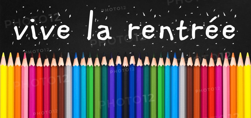 Vive la rentree (meaning Back to school) written on black chalkboard background with colorful wooden pencils