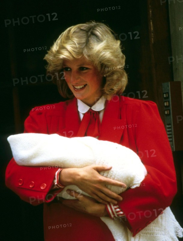 Princess Diana, Princess of Wales, smiles as she carries her newborn baby, Prince Harry, when she leaves St. Mary's Hospital in London in September 1984.