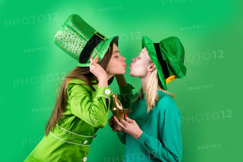 Irish traditions. Young women celebrating St Patrick's Day in pub. Isolated.