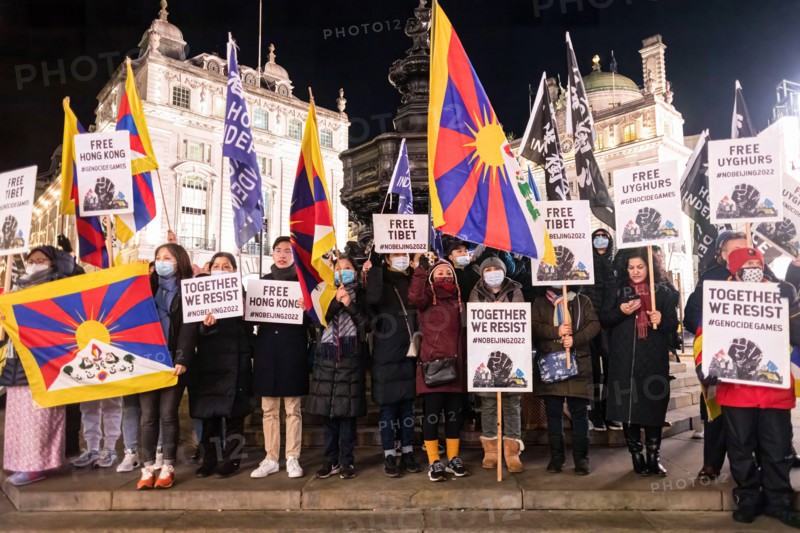 London, UK. 10th Dec, 2021. Protesters seen holding placards and flags during the protest. In celebration of the Human Rights Day (10th Dec), various anti-Chinese Communist Party (anti-CCP) groups in London rallied at Piccadilly Circus, later marching off to 10 Downing Street.  The rally majorly demanded the Western world to boycott the 2022 Beijing Winter Olympic games.
