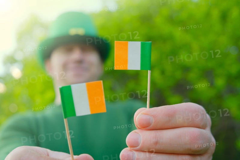 St.Patrick 's Day. Ireland flag and clover flowers .Saint Patrick background. Irish traditional spring holiday.