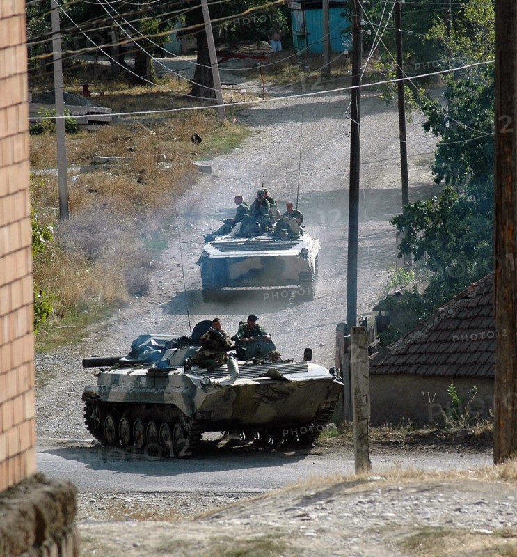 Infantry and armored personnel carriers of Russia's 17th Motor Rifle Division move through the Georgian village Igoeti, 16 August 2008. Russian President Dmitry Medvedev on Saturday signed a ceasefire agreement ending hostilities with Georgia over the breakaway region of South Ossetia. Georgian media reports said that Russian troops in Georgia were making no preparations for withdr