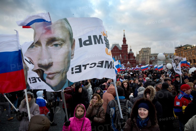 People at the rally-concert "We are together" in support of the annexation of Crimea and Sevastopol to Russia on Red square of Moscow on March 18,2014