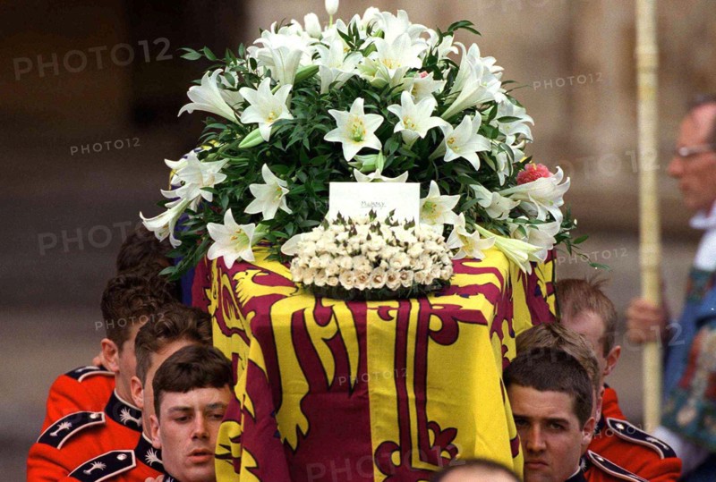The coffin of Diana, Princess of Wales leaves Westminster Abbey after the funeral service on September 6, 1997. The touching floral tribute from her sons says simpky 'Mummy'.