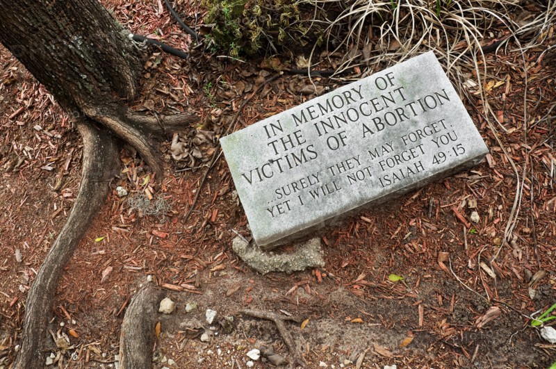 abortion grave marker in garden of church