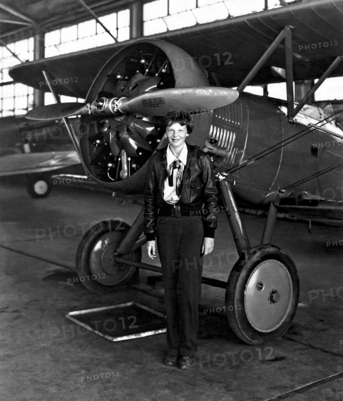 Aviation pioneer Amelia Earhart poses with her airplane in a hangar July 30, 1936. Earhart was the first female aviator to fly solo across the Atlantic Ocean