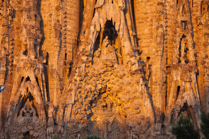 Sagrada Familia by Antoni Gaudi at sunrise in Barcelona, Catalonia, Spain. Nativity Facade, portals of Hope, Charity and Faith.