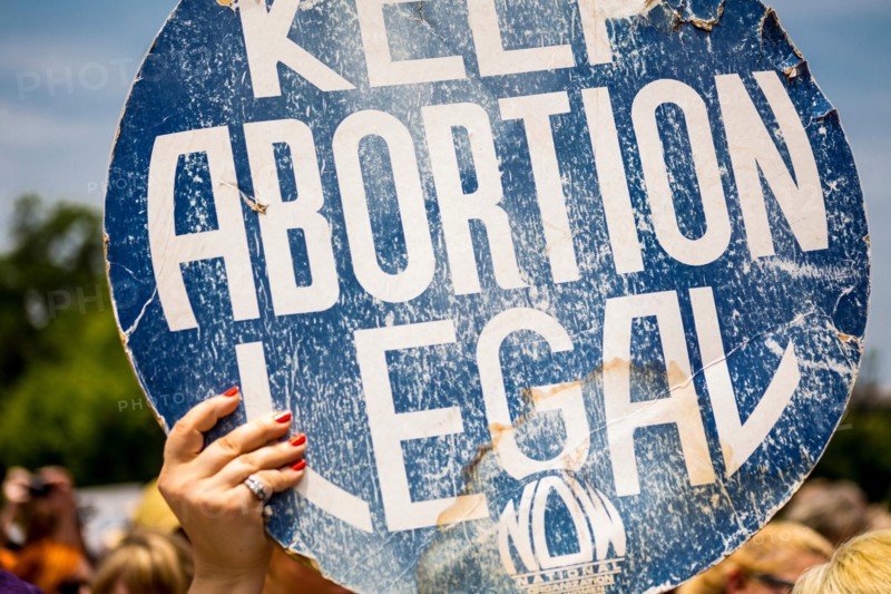 A women holds up a Keep Abortion Legal sign. Outside the capital building in Austin, Texas