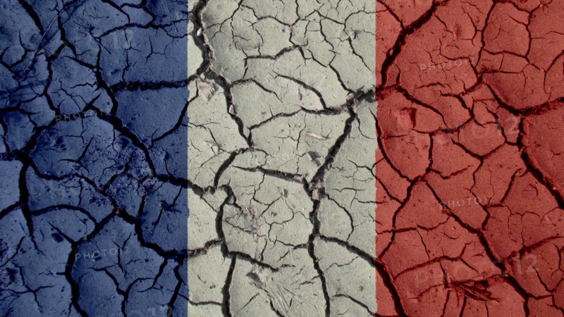 Political Crisis Or Environmental Concept: Mud Cracks With France Flag