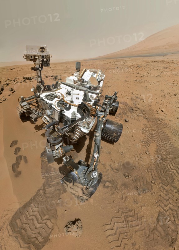 On Sol 84 (Oct. 31, 2012), NASA's Curiosity rover used the Mars Hand Lens Imager (MAHLI) to capture this set of 55 high-resolution images, which were stitched together to create this full-color self-portrait. The mosaic shows the rover at "Rocknest," the spot in Gale Crater where the mission's first scoop sampling took place. Four scoop scars can be seen in the regolith in front of the rover. The base of Gale Crater's 3-mile-high (5-kilometer) sedimentary mountain, Mount Sharp, rises on the right side of the frame. Mountains in the background to the left are the northern wall of Gale Crater.