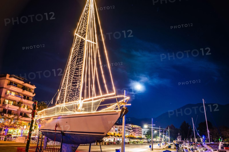 Iconic view of a decorated wooden sailing boat during Christmas period against a starry night in Kalamata city, Messenia, Greece