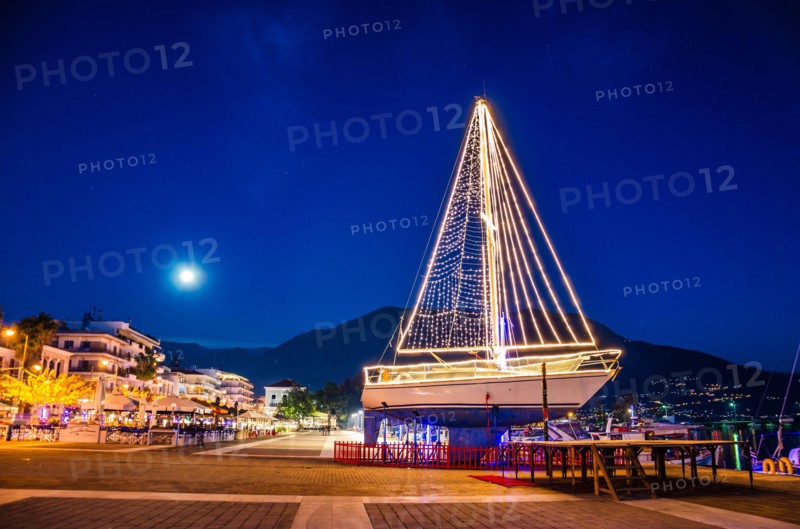 Iconic view of a decorated wooden sailing boat during Christmas period against a starry night in Kalamata city, Messenia, Greece