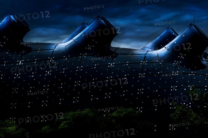 Graz/Austria - August 2019: Glass roof of the Kunsthaus in Graz; Friendly Alien; dark blue toned