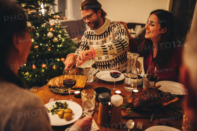 European family having christmas dinner together. Family celebrating christmas together at home.