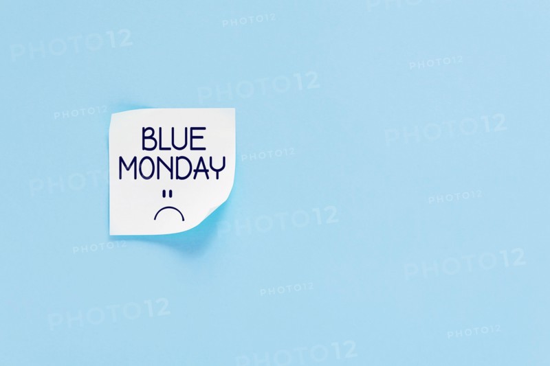 Blue monday text with sad smiley face. Sticker on blue wall. Most depressing and saddest day of the year. Blue monday concept. Copy space.