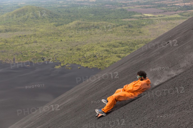 A Volcano surfer slides down Cerro Negro Volcano.