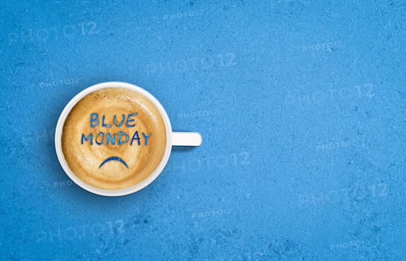 Sade face in cup of coffee. Blue Monday concept.