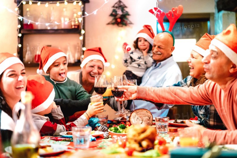 Big multi generation family toasting at christmas dinner feast - Winter holiday x mas concept with parents and children eating together at home supper