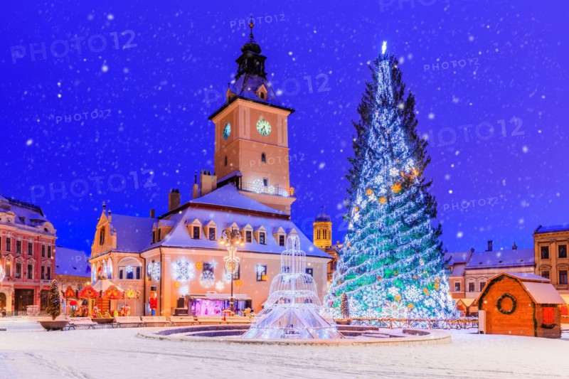 Brasov, Romania. Old Town Christmas Market at twilight with snow effect.