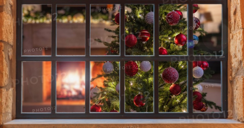 Christmas window. Xmas tree decoration, burning fireplace, winter holiday home interior, view from outdoors