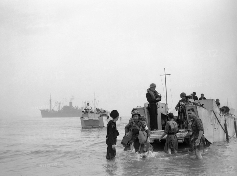 Troops and ammunition being brought ashore from LCAs (landing craft assault) at Arzeau in Algeria during Operation 'Torch', November 1942. Troops and ammunition for light guns being brought ashore from a landing craft assault (ramped) (LCA 428) on Arzeau beach, Algeria, North Africa, whilst another LCA (LCA 287) approaches the beach.